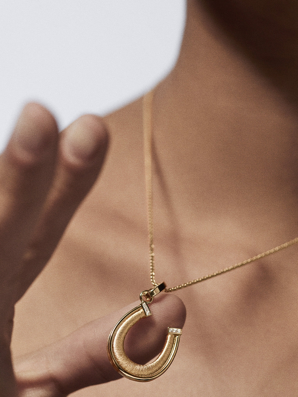 HORSESHOE GOLD AND DIAMOND PENDANT
